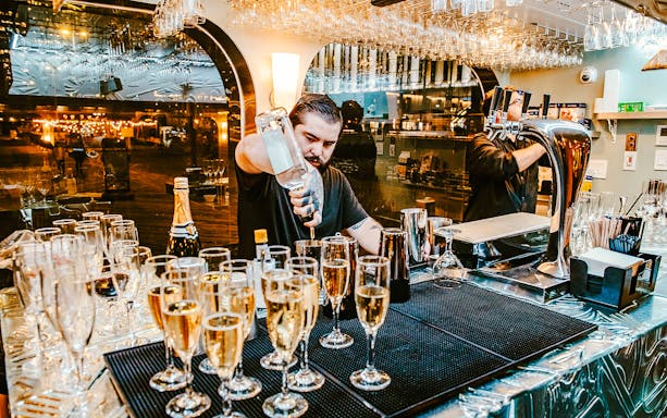 Bartender preparing drinks on New Year's Eve dinner cruise.