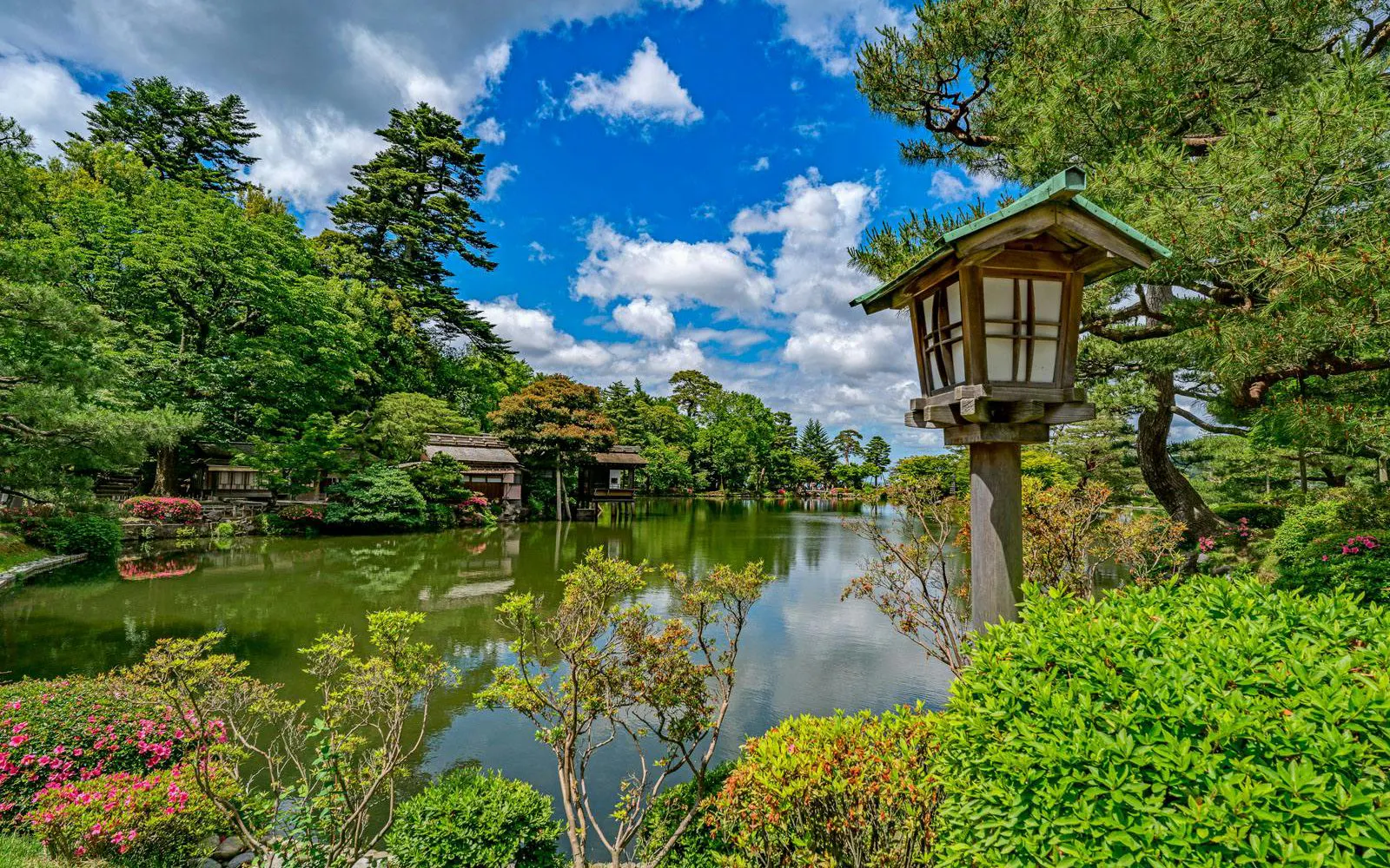 Kenroku-en garden with pond and traditional lantern in Kanazawa, Ishikawa, Japan.