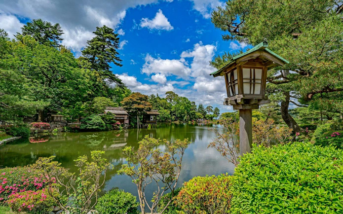 Kenroku-en garden with pond and traditional lantern in Kanazawa, Ishikawa, Japan.