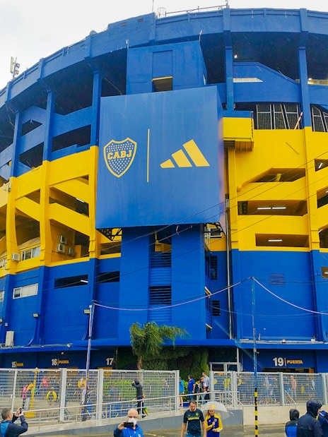 La Bombonera stadium exterior with people walking outside, Buenos Aires, Argentina.