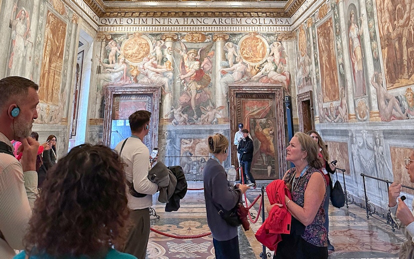 Visitors exploring frescoes inside Castel Sant'Angelo, Rome.