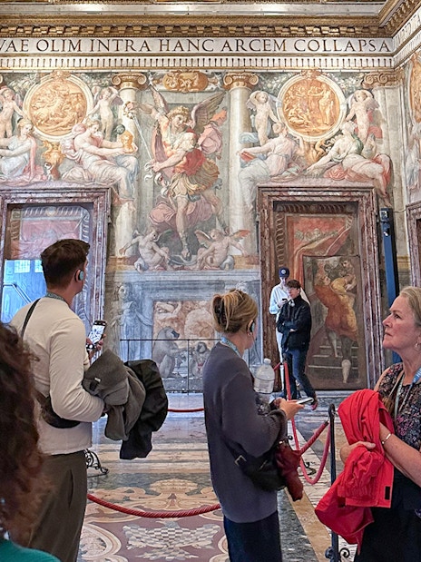 Visitors exploring frescoes inside Castel Sant'Angelo, Rome.