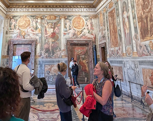 Visitors exploring frescoes inside Castel Sant'Angelo, Rome.