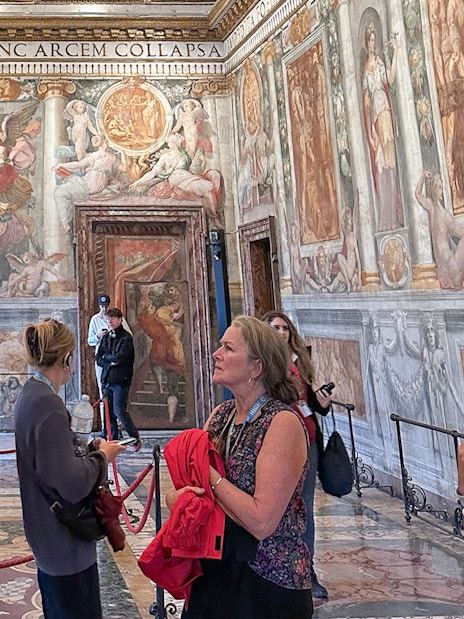 Visitors exploring frescoes inside Castel Sant'Angelo, Rome.