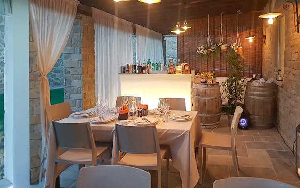 Dinner setup in a rustic Chianti setting with wine barrels and a bar, part of the eBike tour experience.