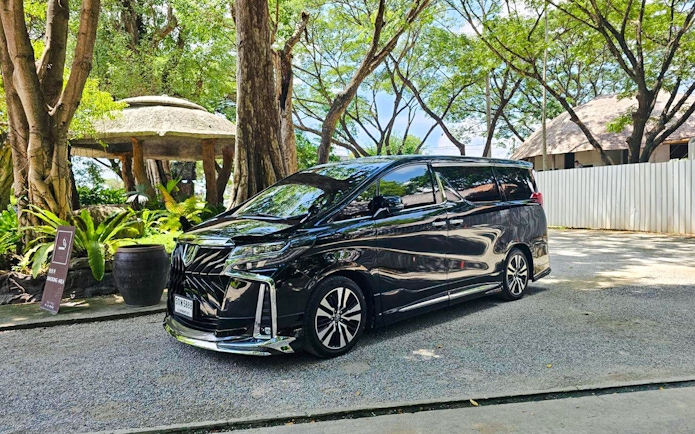 Black luxury van for private Doi Inthanon tour in leafy Chiang Mai area.