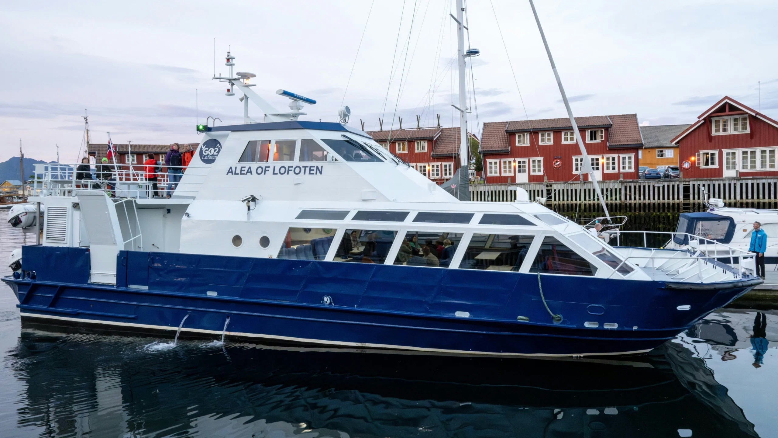 Cruise boat Alea of Lofoten docked at Trollfjord, Lofoten with passengers on deck.