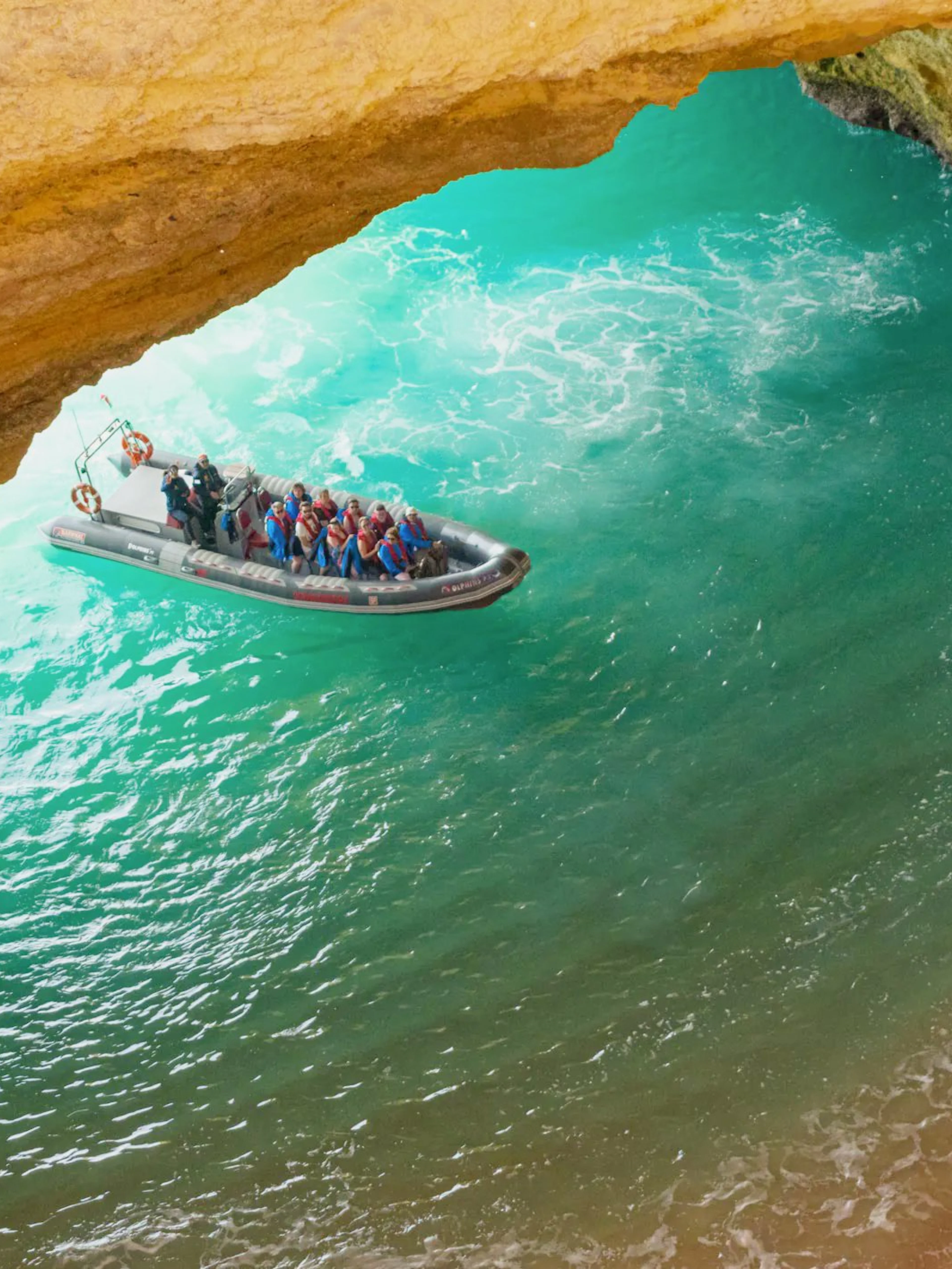 Tourists on RIB boat entering Benagil Caves, Algarve, Portugal.