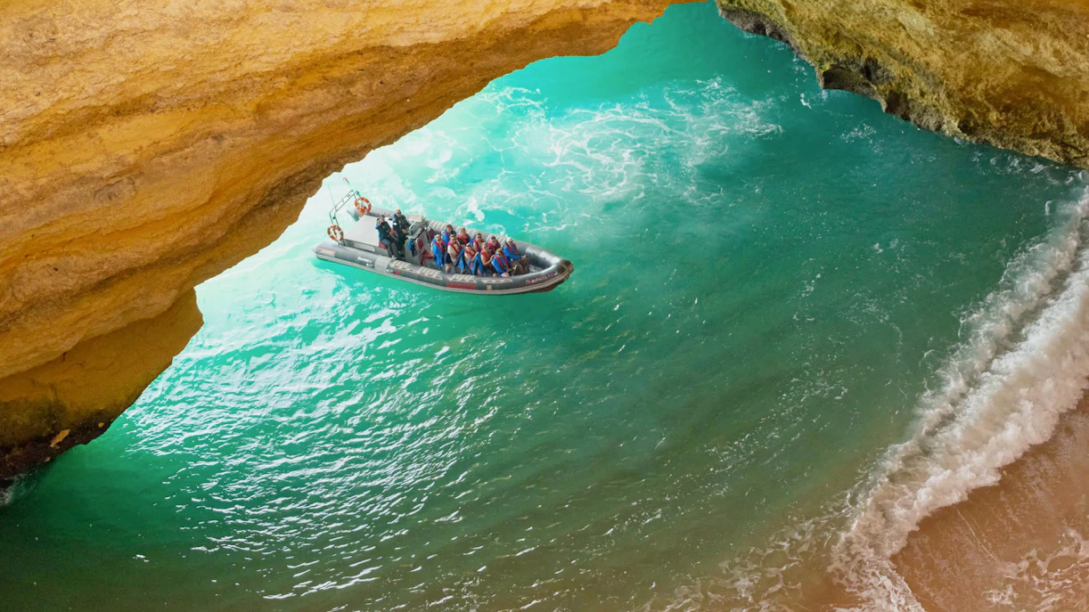 Tourists on RIB boat entering Benagil Caves, Algarve, Portugal.