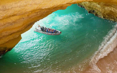 Tourists on RIB boat entering Benagil Caves, Algarve, Portugal.