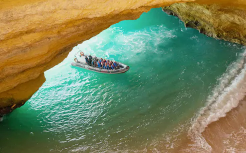 Tourists on RIB boat entering Benagil Caves, Algarve, Portugal.