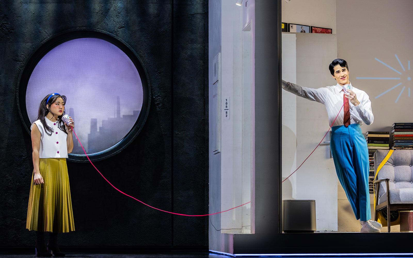 Actors performing Maybe Happy Ending Broadway show with a tin can phone on stage.
