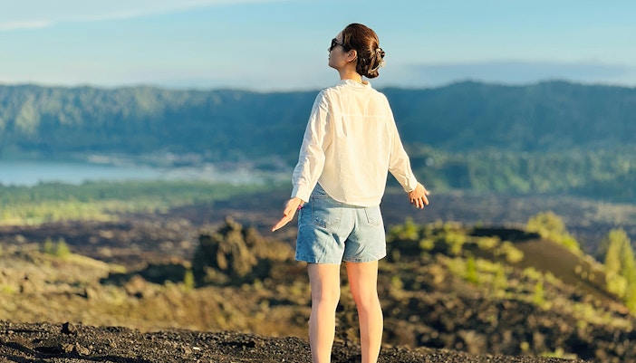 Kintamani landscape view with a person enjoying the sunset on a private 4WD Jeep tour.