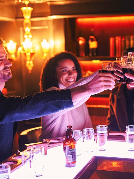 Group toasting with Guinness at Dublin's Connoisseur Experience bar.