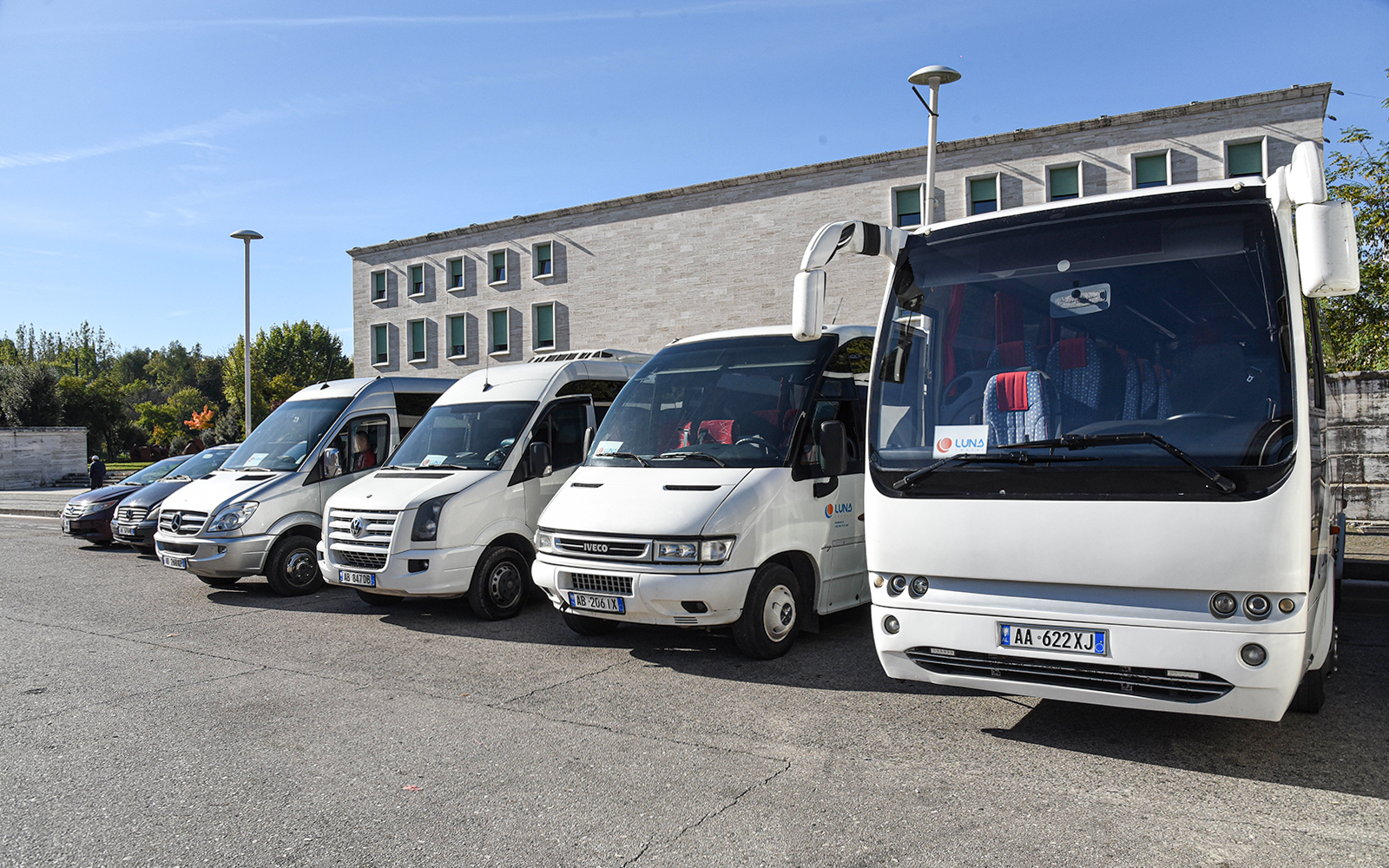 Buses parked at Tirana Airport for transfers to Tirana Central.