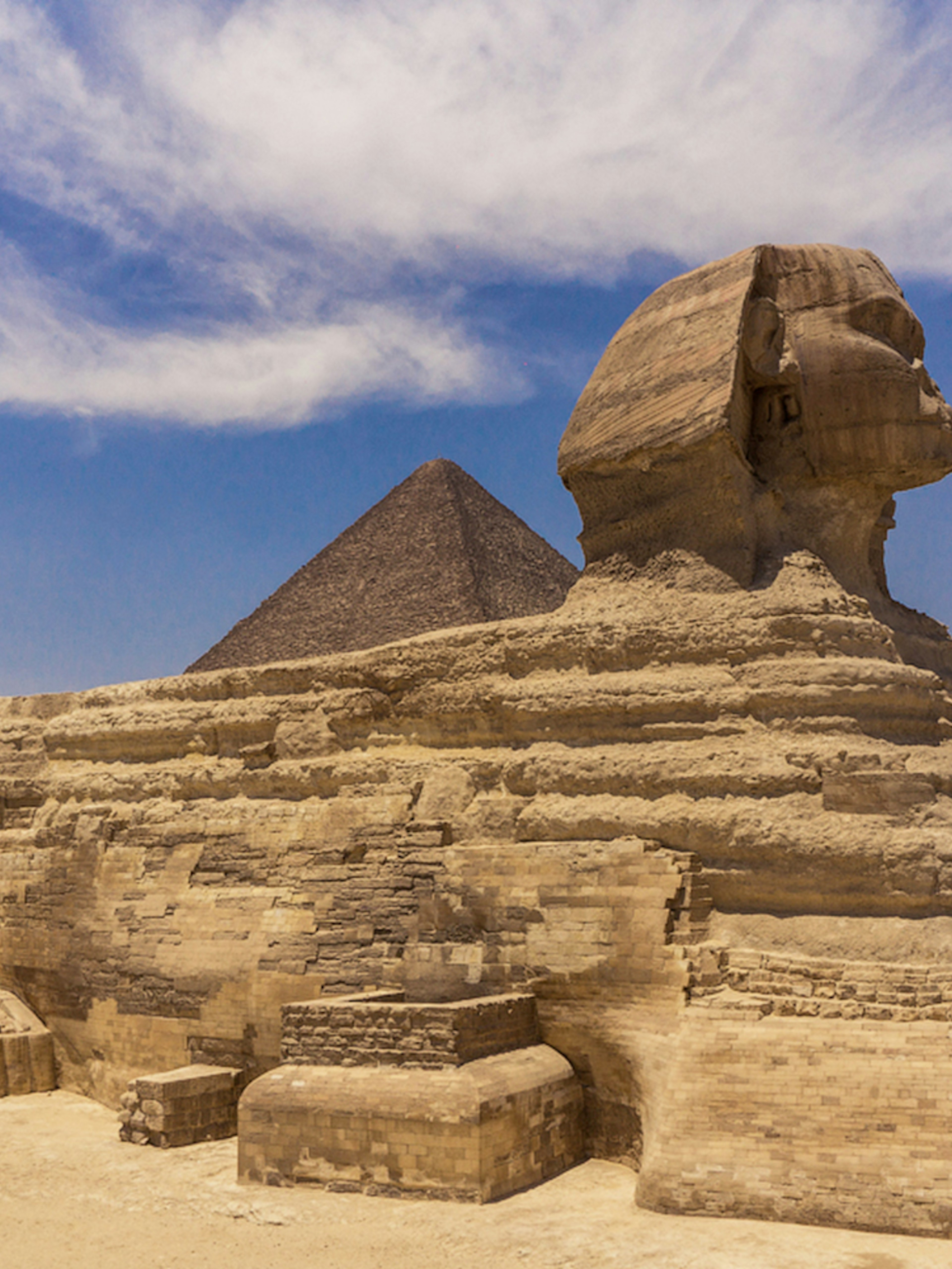 Sphinx and Pyramid in Giza under a clear blue sky.