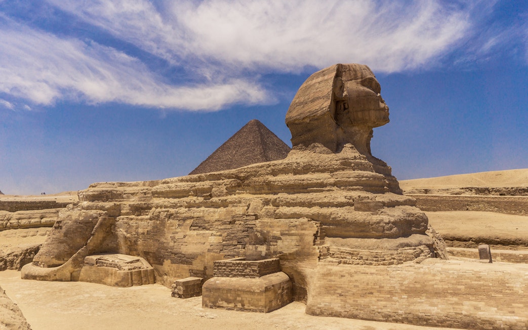 Sphinx and Pyramid in Giza under a clear blue sky.