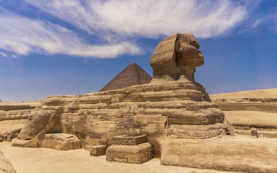 Sphinx and Pyramid in Giza under a clear blue sky.