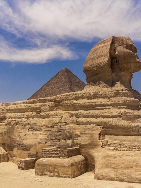 Sphinx and Pyramid in Giza under a clear blue sky.