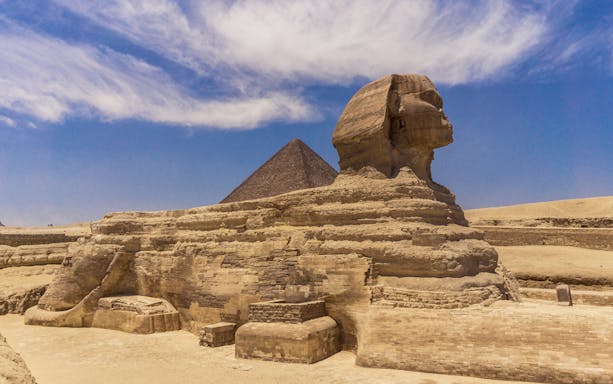 Sphinx and Pyramid in Giza under a clear blue sky.