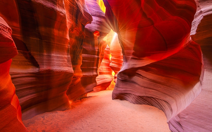 Lower Antelope Canyon's vibrant sandstone walls with sunlight streaming through.