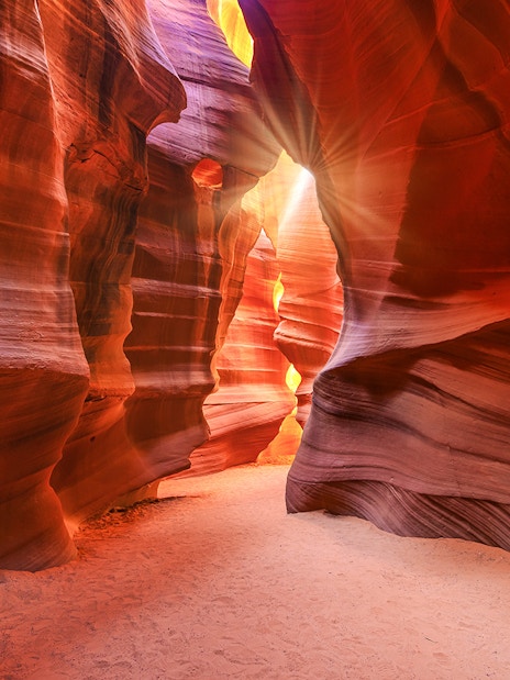 Lower Antelope Canyon's vibrant sandstone walls with sunlight streaming through.