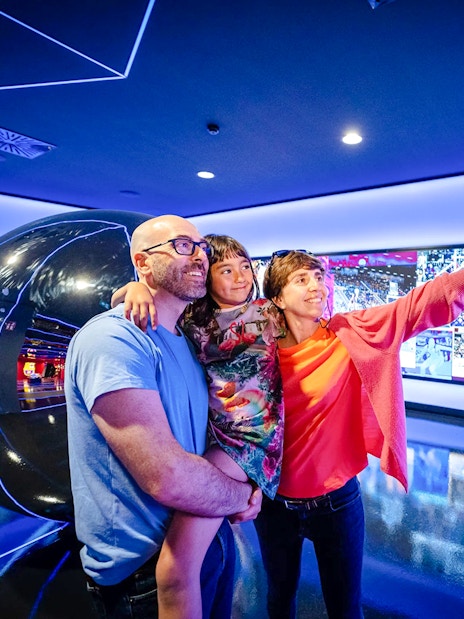 Family taking a selfie at the Barça Museum in Spotify Camp Nou, Barcelona.