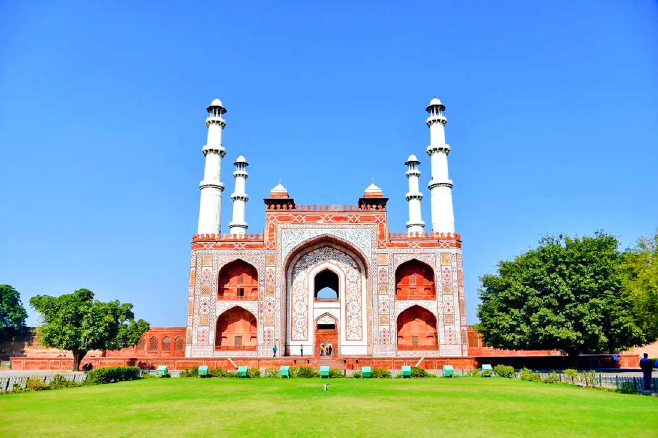 Akbar's Tomb in Agra with intricate Mughal architecture and lush gardens.