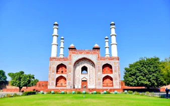 Akbar's Tomb in Agra with intricate Mughal architecture and lush gardens.