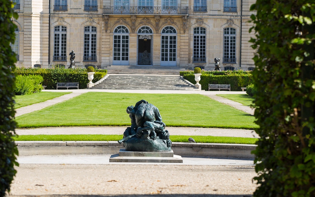 Rodin Museum garden with sculpture and historic building in Paris.