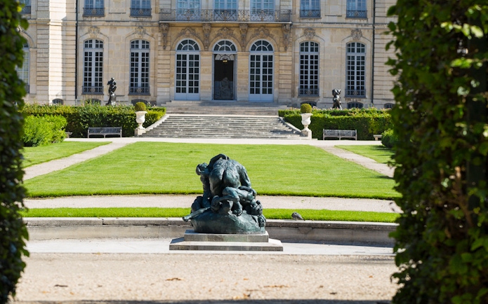Rodin Museum garden with sculpture and historic building in Paris.