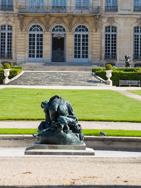 Rodin Museum garden with sculpture and historic building in Paris.