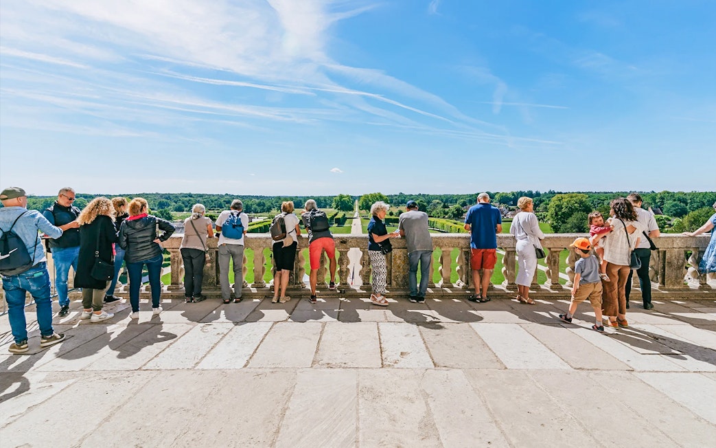 Visitors enjoying the view from the balcony of Chambord Castle, France.