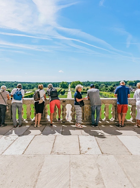 Visitors enjoying the view from the balcony of Chambord Castle, France.