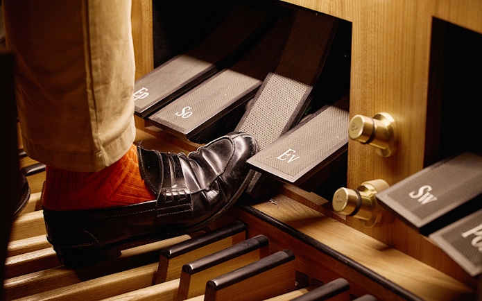Organist's foot on pedal at St. Stephen's Cathedral concert.