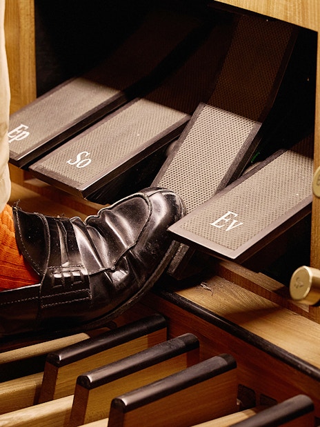 Organist's foot on pedal at St. Stephen's Cathedral concert.