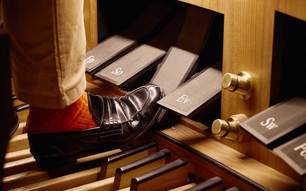Organist's foot on pedal at St. Stephen's Cathedral concert.