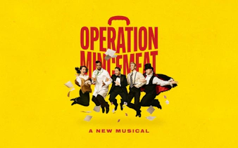 Cast of Operation Mincemeat musical jumping with papers on yellow background, Broadway