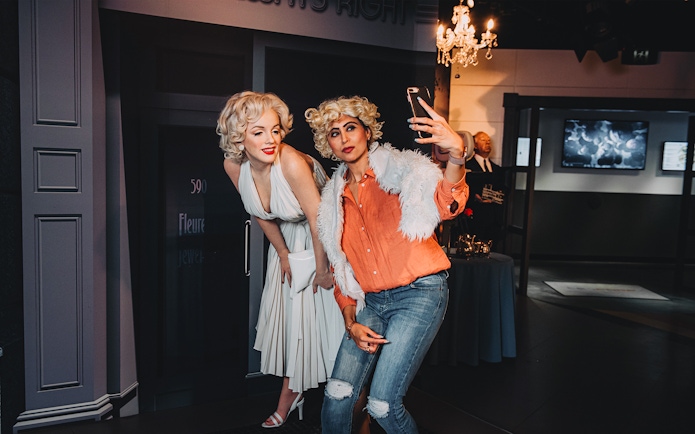Visitors take a selfie with Marilyn Monroe wax figure at Madame Tussauds Sydney.