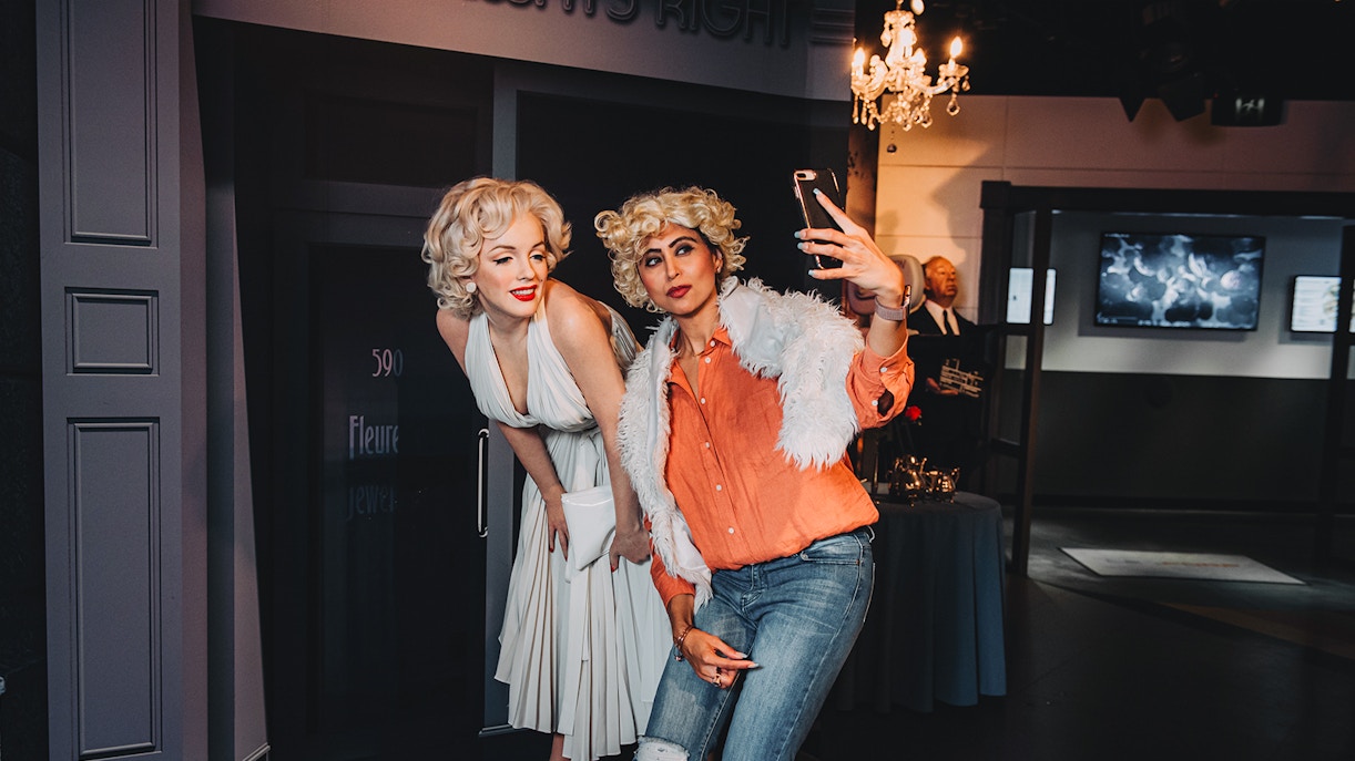 Visitors posing with Marilyn Monroe wax figure at Madame Tussauds Sydney.