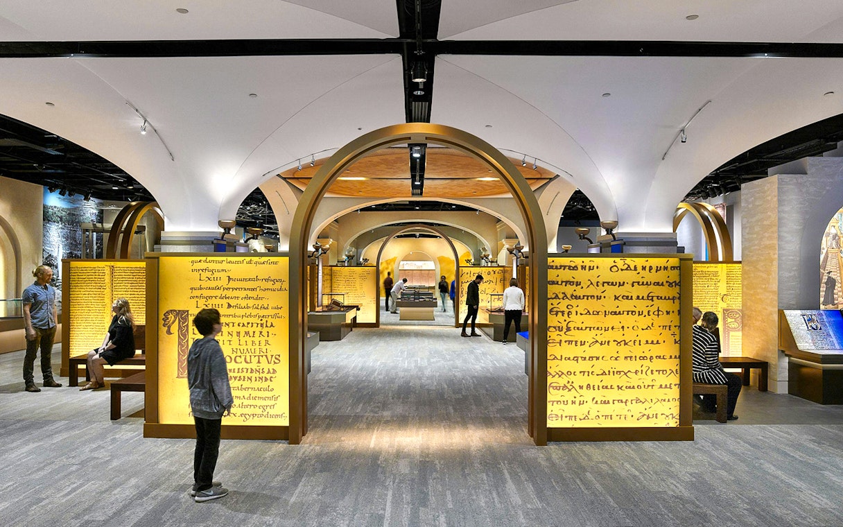 Visitors exploring exhibits at the Museum of the Bible, featuring ancient manuscripts and interactive displays.