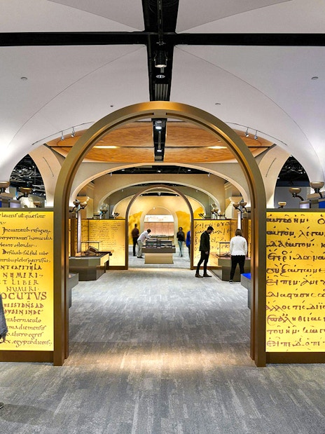 Visitors exploring exhibits at the Museum of the Bible, featuring ancient manuscripts and interactive displays.