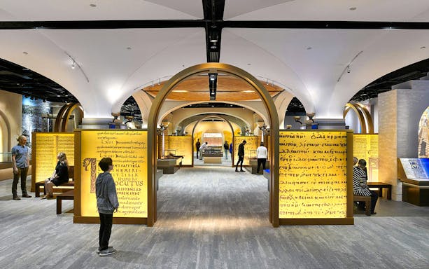 Visitors exploring exhibits at the Museum of the Bible, featuring ancient manuscripts and interactive displays.