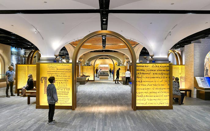 Visitors exploring exhibits at the Museum of the Bible, featuring ancient manuscripts and interactive displays.