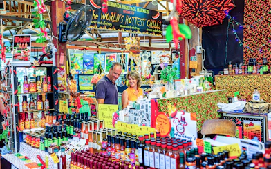 Couple exploring spice stall at Kuranda Heritage Market.