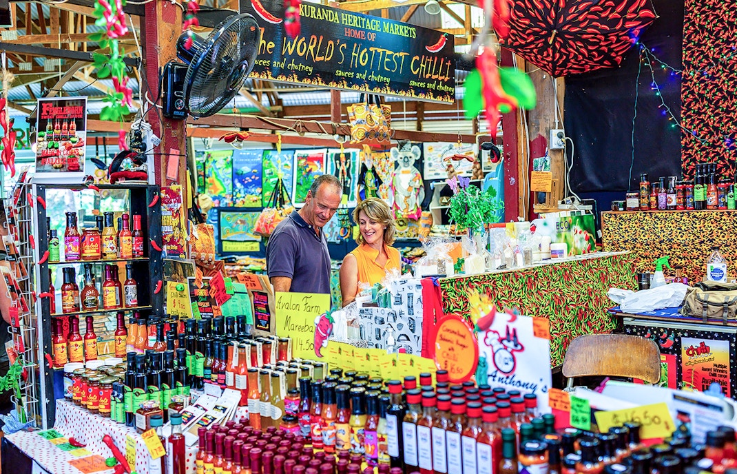 Couple exploring spice stall at Kuranda Heritage Market.