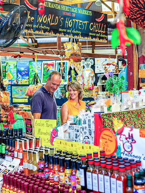 Couple exploring spice stall at Kuranda Heritage Market.