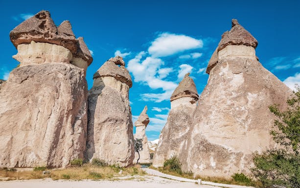 Rock formations in Pasabag Monks Valley, Cappadocia, Turkey under a clear blue sky.