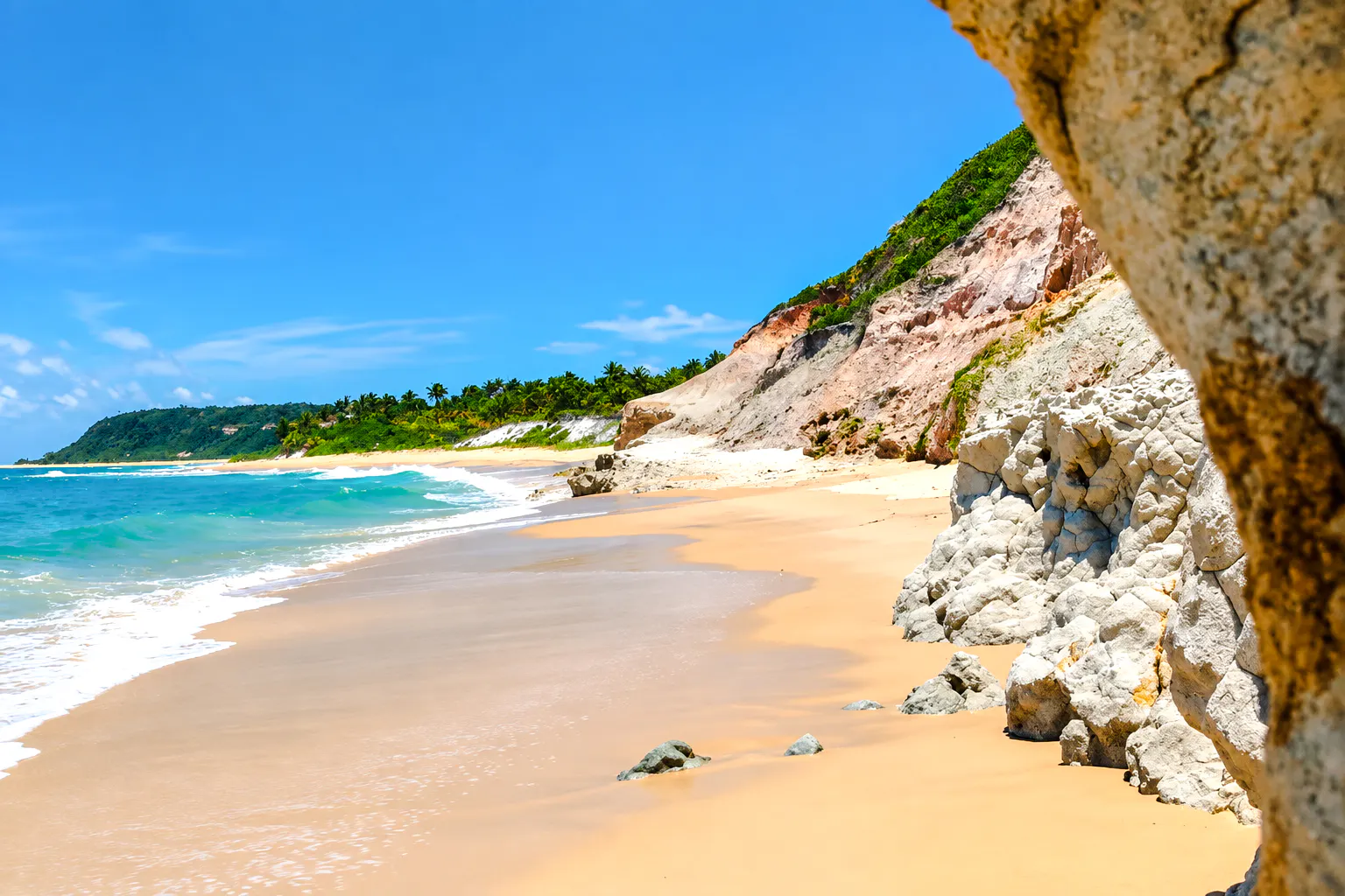 Praia do Espelho coastline with cliffs and turquoise water, Porto Seguro, Brazil.