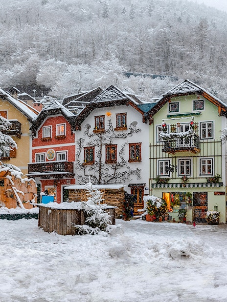 Old town buildings covered in snow during winter, Hallstatt.